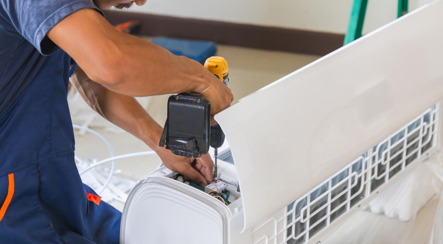 Air conditioning technicians install new air conditioners in homes, Repairman fix air conditioning systems, Male technician service for repair and maintenance of air conditioners